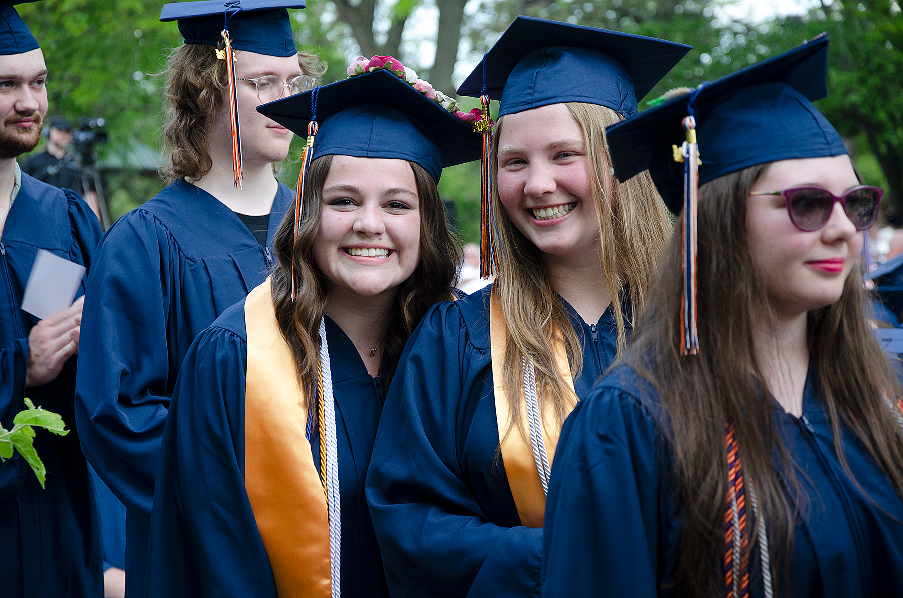 Smiling graduates in caps and gowns